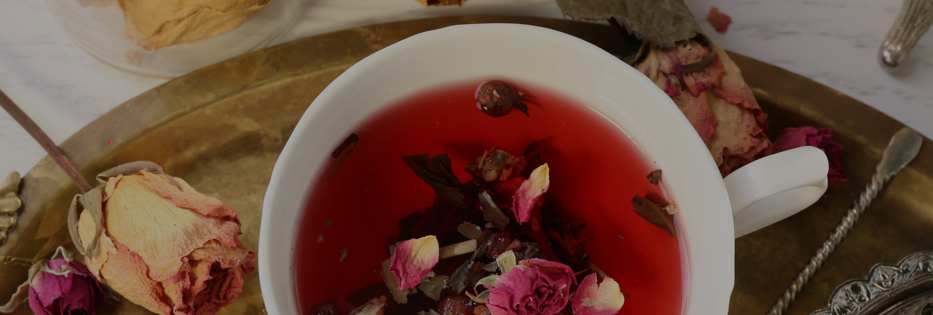 Rose tea with dry roses on a table